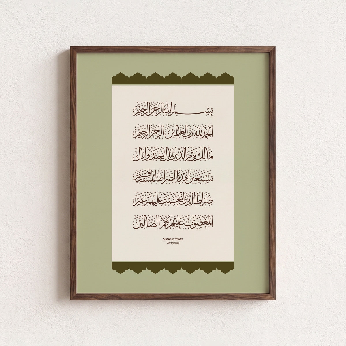 Framed Islamic wall art featuring Arabic calligraphy of Surah Al-Fatiha, presented in a dark brown wooden frame against a textured off-white wall.