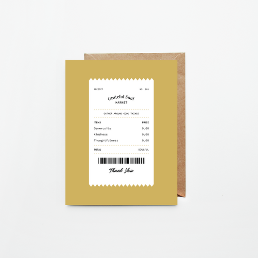 A mustard yellow greeting card with a white receipt-style design and black text, shown in front of a brown kraft envelope on a light gray background.